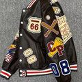 Angled view of a black varsity jacket with colourful baseball-inspired patches and striped cuffs and hem
