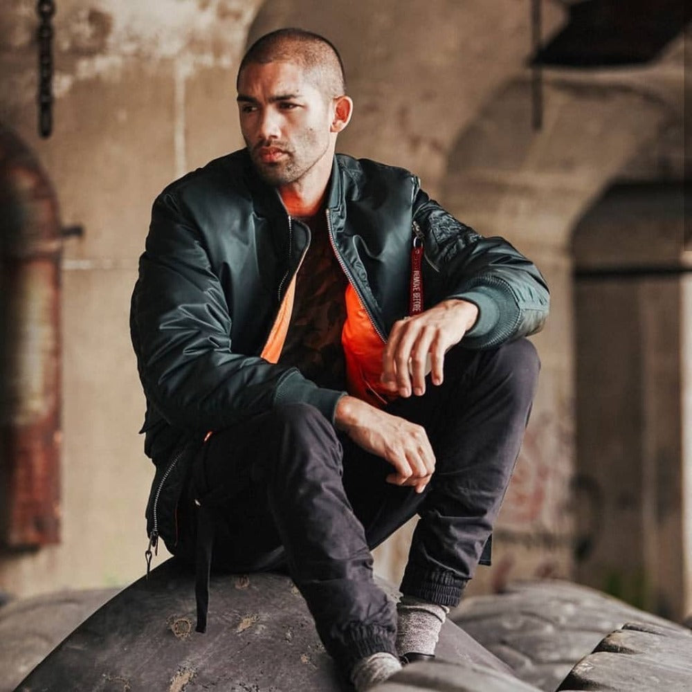 Flight bomber jacket worn open to show the orange lining, with a red sleeve pocket pull tab
