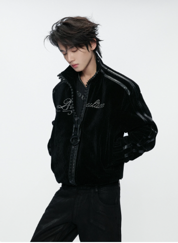 Black zip-up jacket worn with the stand collar open, showing chest script and contrasting shoulder stripes
