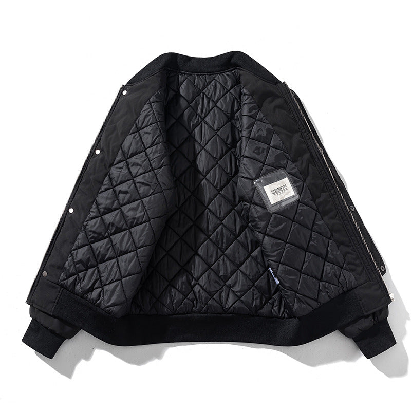Interior view of the black bomber jacket showing diamond-quilted lining
