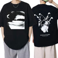 Black graphic T-shirt shown front and back, with fanged mouth and hand-and-string artwork
